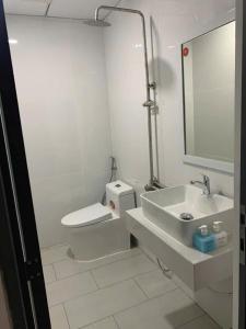 a white bathroom with a toilet and a sink at Khách sạn EDEN Chơn Thành in Chơn Thành