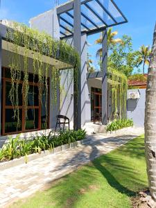 a house with a pergola and a yard at Isle Weligama in Weligama