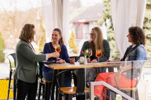 a group of women sitting at a table with wine glasses at Gasthof Kraxner in Hatzendorf