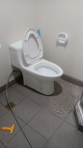a toilet with the seat up in a bathroom at Janeeka's Airie Avida Riala Cebu in Cebu City