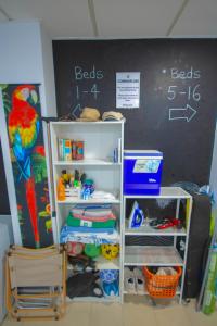 a classroom with a chalkboard and a shelf with toys at Hostel Tropical Work in Las Palmas de Gran Canaria