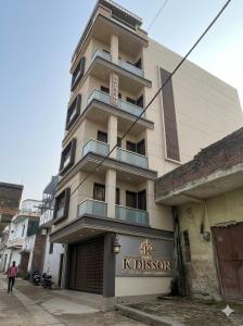 a tall white building with a sign on it at Hotel KDISSON in Mohaniā +11 photos