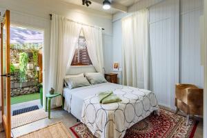 a bedroom with a bed and a large window at Studio 55 in Mudjimba