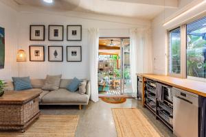 a living room with a couch and a table at Studio 55 in Mudjimba +7 photos