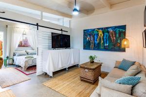 a living room with a couch and a table at Studio 55 in Mudjimba