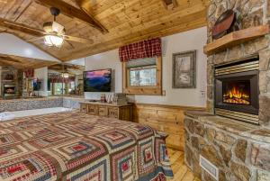 a bedroom with a bed and a fireplace at Mountain Dreams in Sevierville