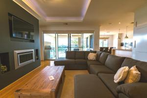 a living room with a couch and a coffee table at Marina Views Mindarie in Mindarie