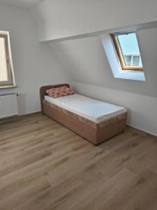a bedroom with a bed in a room with a window at Vodita in Höchstadt an der Aisch