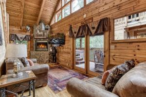 a living room with a couch and a fireplace at Mountain Dreams in Sevierville