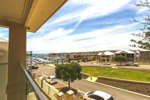 a balcony with a view of a street at Marina Views Mindarie in Mindarie