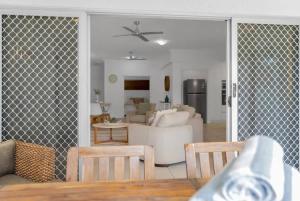 a living room with a couch and a table at 'Eclipse' A Poolside Family Escape in the CBD in Cairns +12 photos
