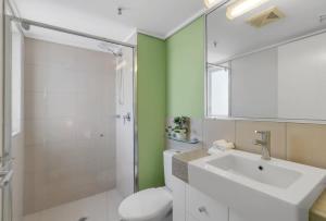 a bathroom with a toilet and a sink and a shower at Peak Studio - Highview Haven across Shopping Centre in Cairns