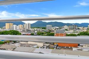 a view of a city from a window at McLeod Nook - Poolside Studio by Waterfront & Market in Cairns