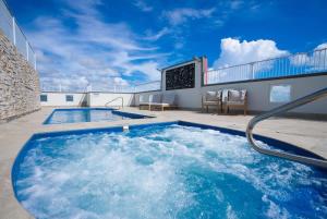 a hot tub on the roof of a building at Cairns City Escape - Elevated Modern Haven with Pool in Cairns