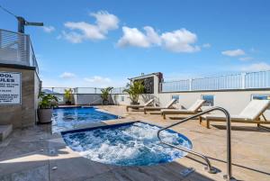 a swimming pool on top of a building at Cairns Central Adjacent Suites, Steps to Esplanade in Cairns