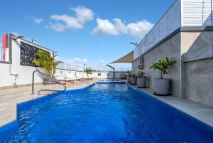 a swimming pool in the middle of a building at Cairns Central Adjacent Suites, Steps to Esplanade in Cairns +34 photos