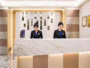 two women sitting at a counter in a lobby at Innk in Taichung