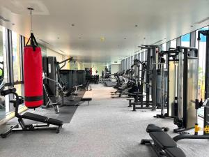 a gym with a row of tread machines and a punching bag at SunQ Haven in Meyhomes in Phú Quốc