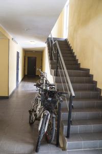 two motorcycles parked in a hallway next to a staircase at Modern Apartment in Tartu