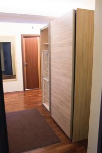 a closet with a wooden door in a room at Modern Apartment in Tartu