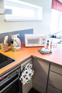 a kitchen with a counter top with a microwave at Modern Apartment in Tartu