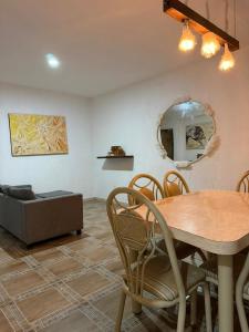 a dining room with a table and a couch at Casa Dixam Luum in Puerto Morelos +32 photos
