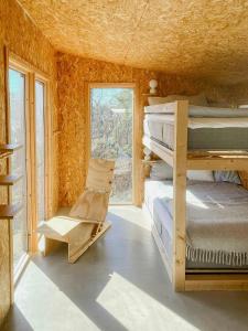 a room with a bunk bed and a chair at Nature And Veranda In Perfect Alignment in Djurhamn