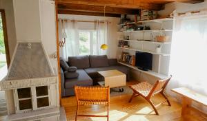 a living room with a couch and a table and chairs at Nature And Veranda In Perfect Alignment in Djurhamn