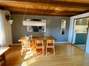 a dining room with a wooden table and chairs at Nature And Veranda In Perfect Alignment in Djurhamn