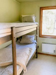 two bunk beds in a room with a window at Nature And Veranda In Perfect Alignment in Djurhamn +5 photos