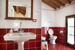 a bathroom with a sink and a toilet at Agriturismo Ca' Guerriera in Sustinente +58 photos