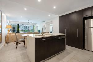 a kitchen with a sink and a counter top at Poolside Relaxation - Resort Retreat with Beach Access in Port Douglas