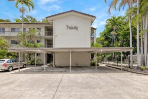 a parking lot in front of a building at The Tropical Trinity - A Breezy Beachside Getaway in Trinity Beach