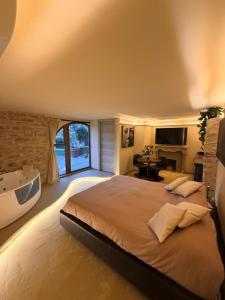 a large bedroom with a large bed and a tub at Borgo Spescia Pool Park and Relaxation in Camposonaldo +46 photos