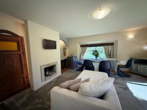 a living room with a couch and a fireplace at Borgo Spescia Pool Park and Relaxation in Camposonaldo