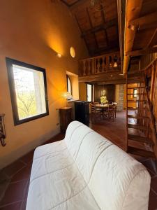 a bedroom with a white bed and a dining room at Borgo Spescia Pool Park and Relaxation in Camposonaldo