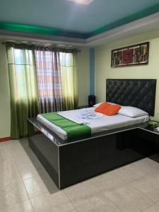 a bedroom with a large bed with a black frame at Hotel Rio Sol in Cali +17 photos