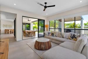a living room with a couch and a table at The Elysian at Argentea - Beachside Stay with Pool in Palm Cove