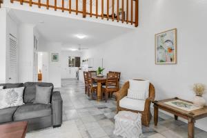 a living room with a couch and a table at Nirvana - Steps to Four Mile Beach with Shared Pool in Port Douglas