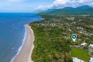 an aerial view of the shoreline of a beach at Nirvana - Steps to Four Mile Beach with Shared Pool in Port Douglas