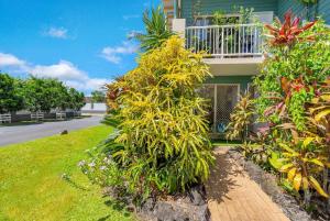 a house with plants on the side of a street at Wallaby Beach House - Resort-style Comforts in Trinity Beach