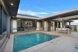 a swimming pool in the backyard of a house at Trinity Beach Oasis - Poolside Retreat and Serenity in Trinity Beach
