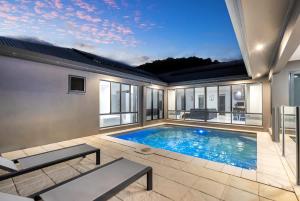 a swimming pool in a house with a large window at Trinity Beach Oasis - Poolside Retreat and Serenity in Trinity Beach +38 photos