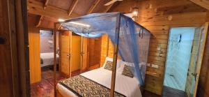 a bedroom with a canopy bed in a cabin at Sasvi Cabana in Trincomalee