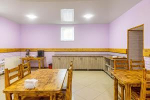 a dining room with wooden tables and chairs at Обійми Embrace in Truskavets