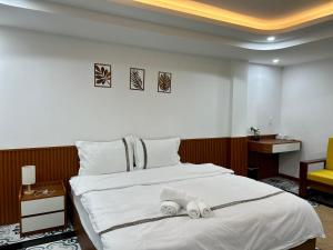 a hotel room with a bed with towels on it at Han House's Apartment in Danang