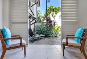 a balcony with two chairs and a patio at 'Saltwater Studio' Experience Resort-style Bliss in Craiglie