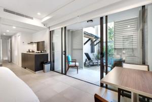 a bedroom with a bed and a table and a kitchen at 'Saltwater Studio' Experience Resort-style Bliss in Craiglie