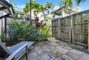 a backyard with a wooden fence and a bench at 'Saltwater Studio' Experience Resort-style Bliss in Craiglie