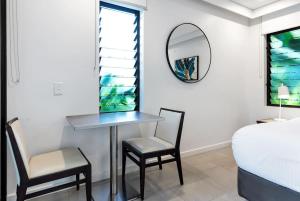 a bedroom with a table and two chairs and a mirror at 'Saltwater Studio' Experience Resort-style Bliss in Craiglie +8 photos